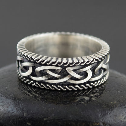 Sterling silver Viking ring seen front on, plaited Norse knot between two twisted rope borders