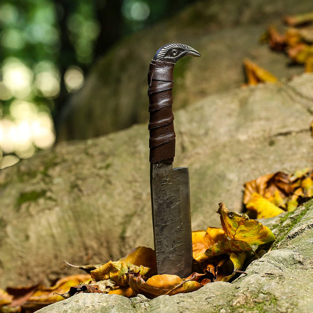 Close-up of the cast raven's head pommel and leather-wrapped grip on the Odin's Raven seax knife