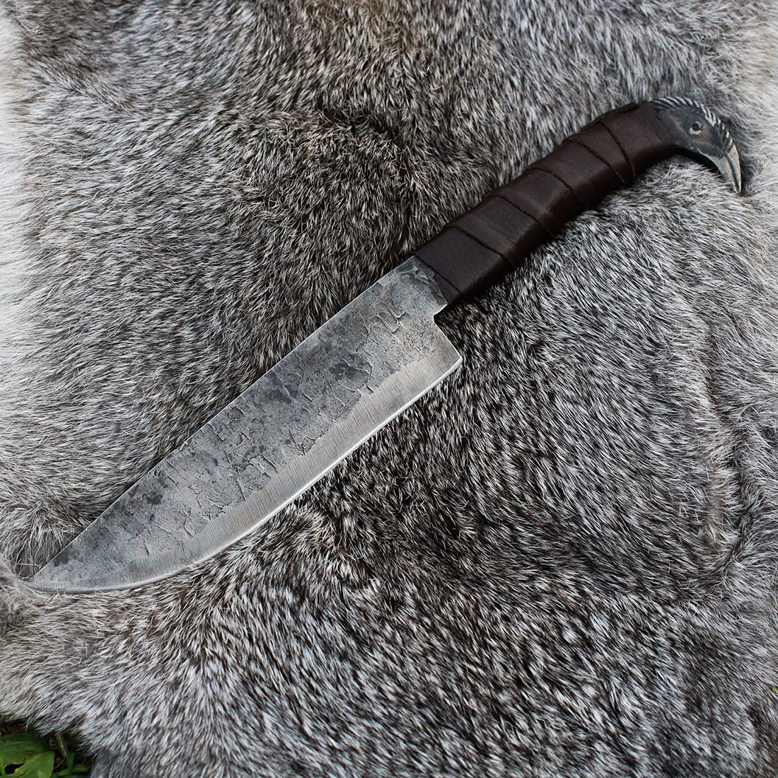 Full view of the Odin's Raven seax knife with its 6.5-inch hand-forged carbon steel blade and raven's head pommel
