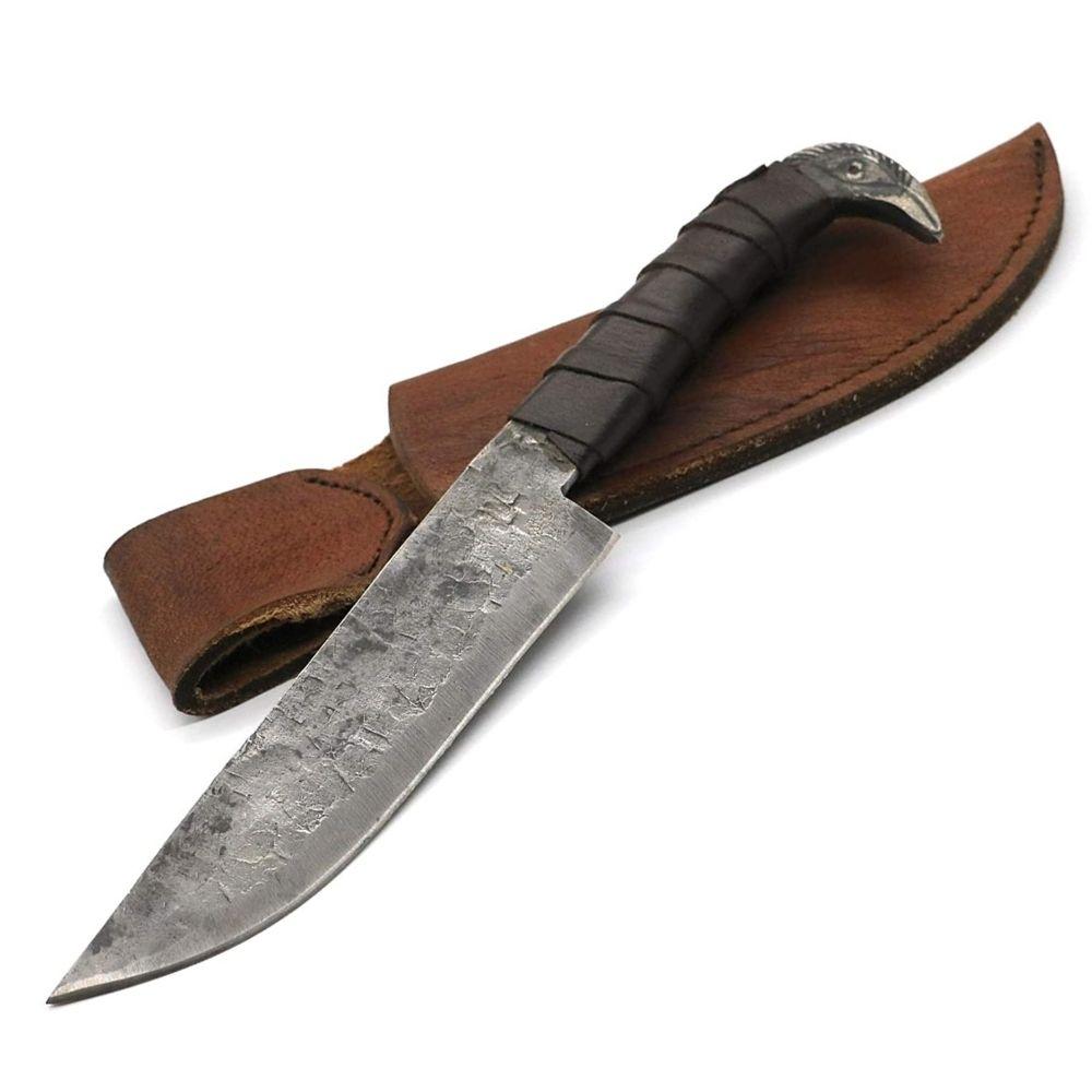 Hand-forged Viking seax knife with leather-wrapped grip and raven's head pommel shown with its brown leather belt sheath