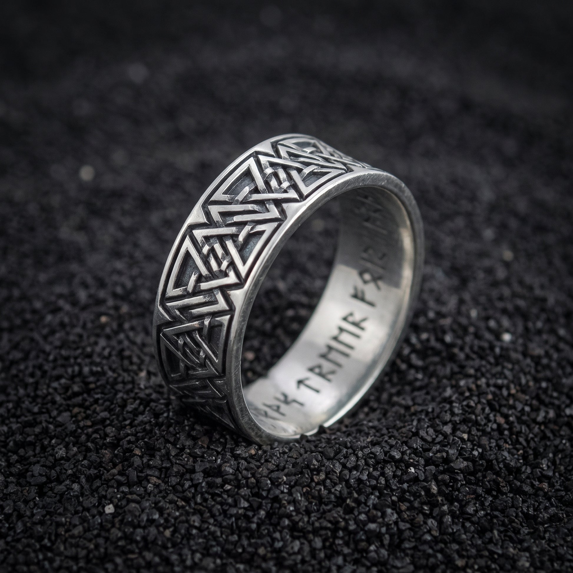 Valknut and rune band ring in 925 sterling silver on black volcanic sand