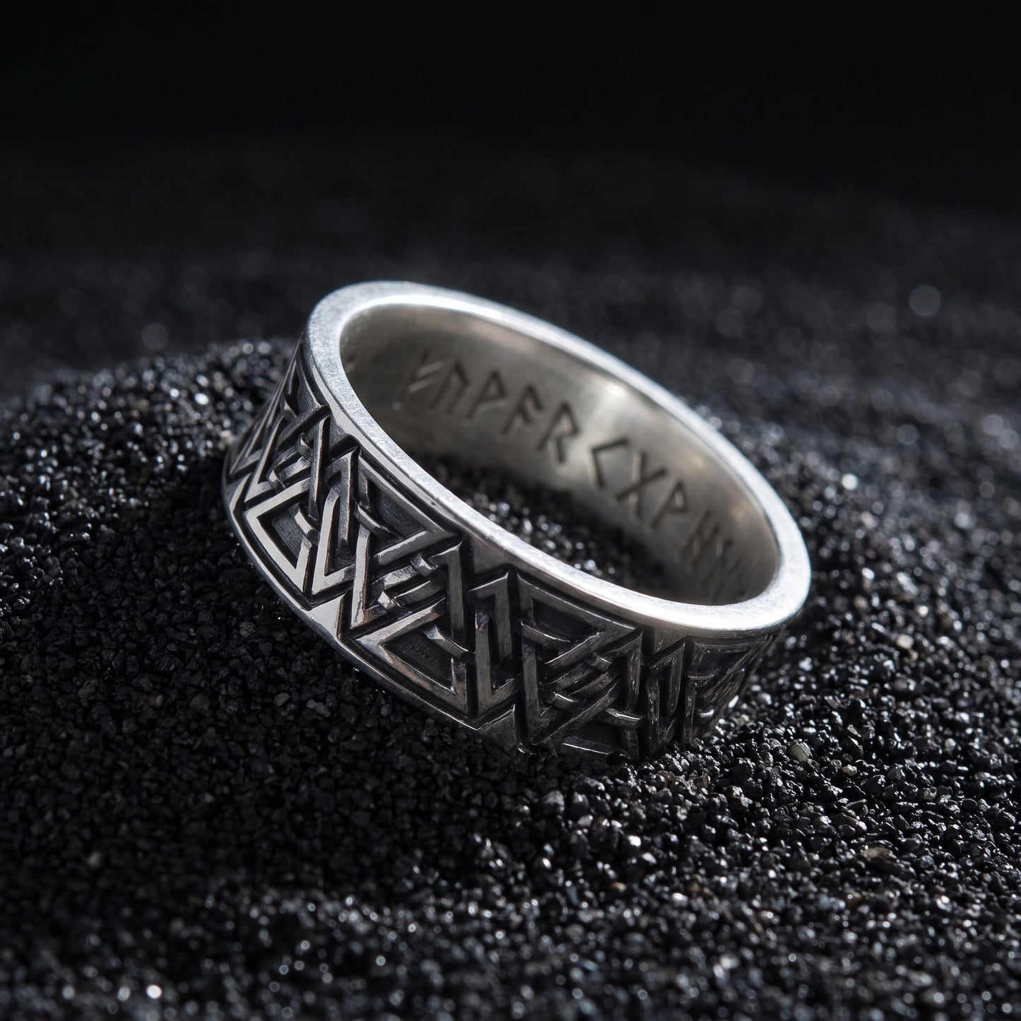 Valknut rune ring from the side, polished rims and engraved runes inside the band