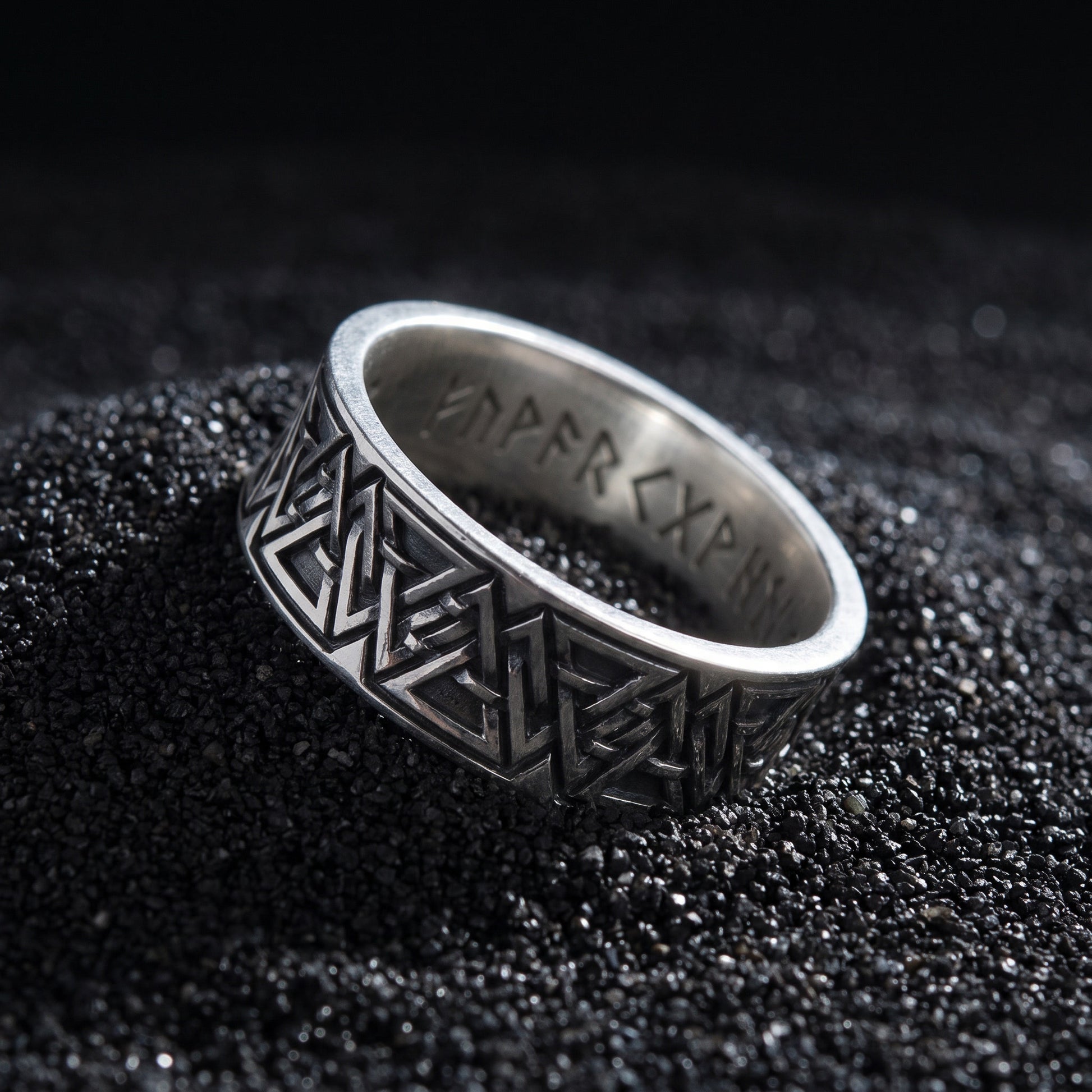 Valknut rune ring from the side, polished rims and engraved runes inside the band