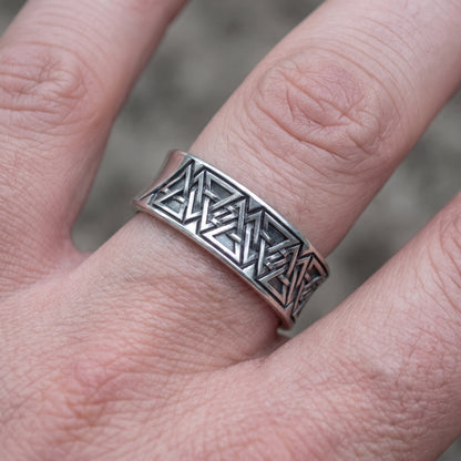 Valknut rune band ring worn on a finger, showing the width of the silver band