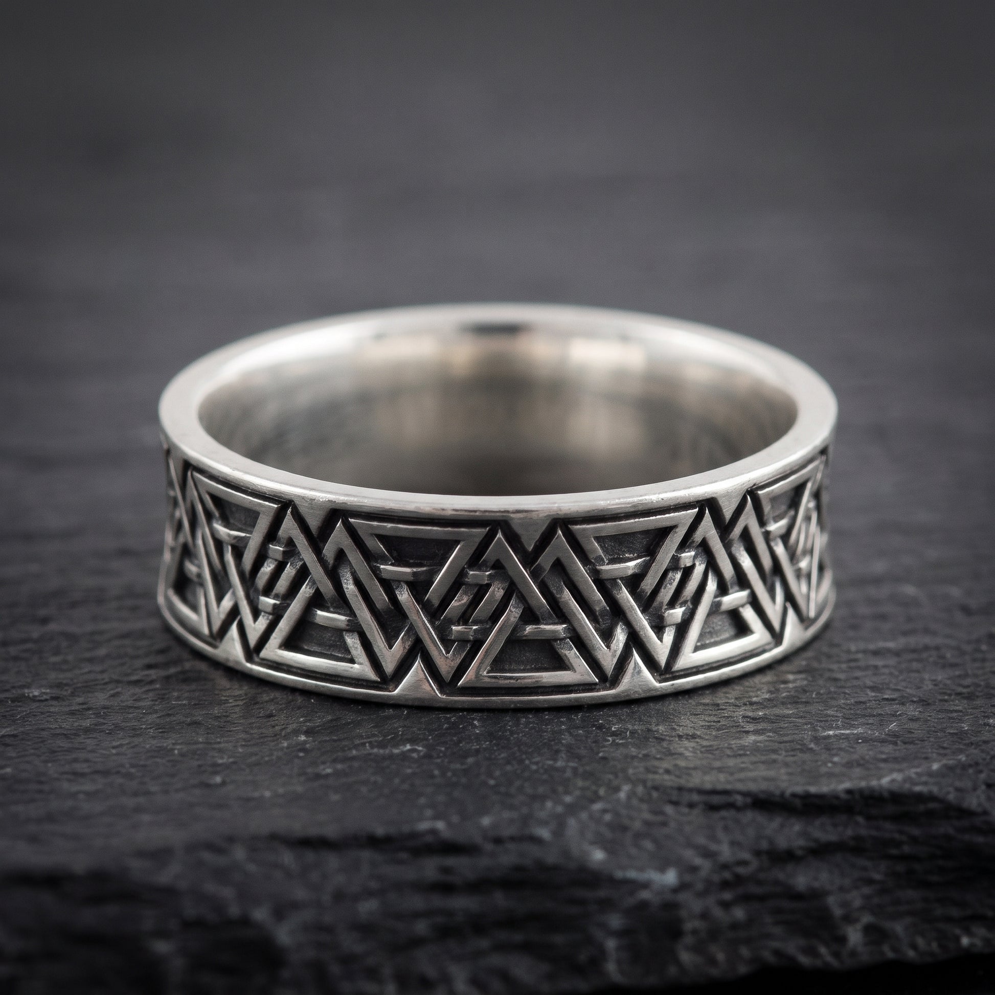 Close view of the interlocking valknut symbols on the oxidised silver band
