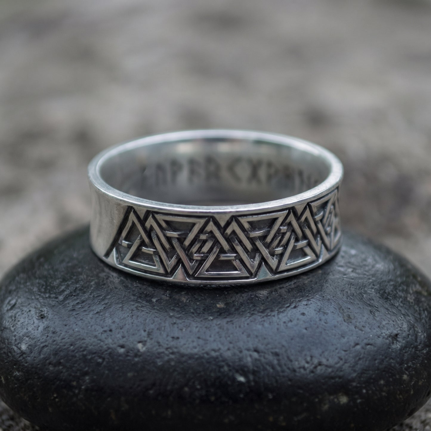 Sterling silver Valknut wedding ring seen front on, interlocking valknut frieze