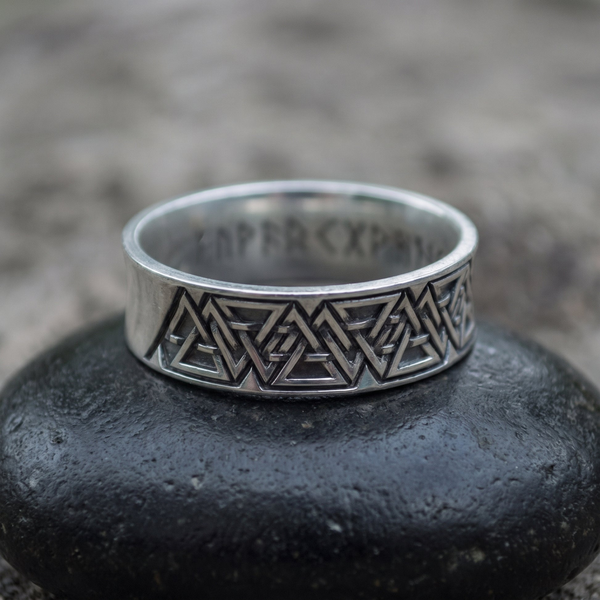 Sterling silver Valknut wedding ring seen front on, interlocking valknut frieze