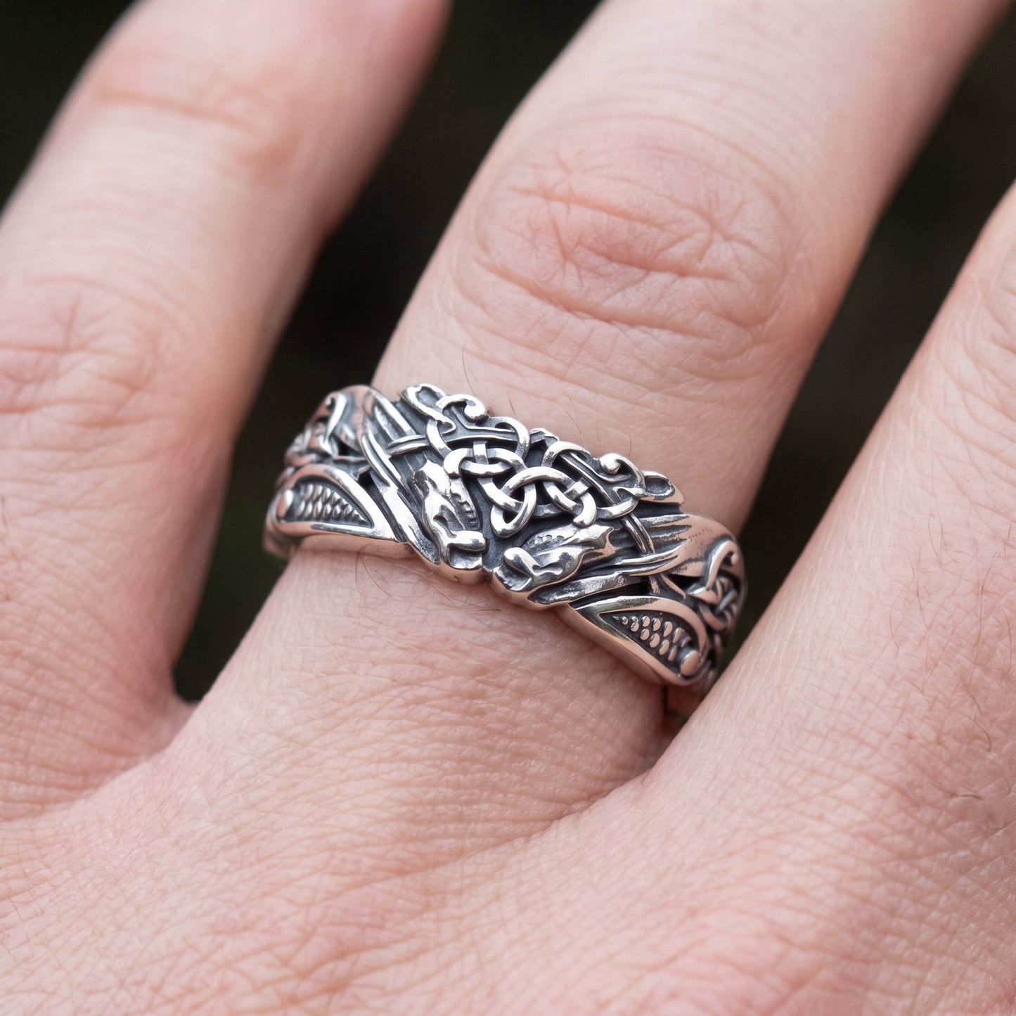 Viking wedding band worn on a finger, close up showing the width of the ring