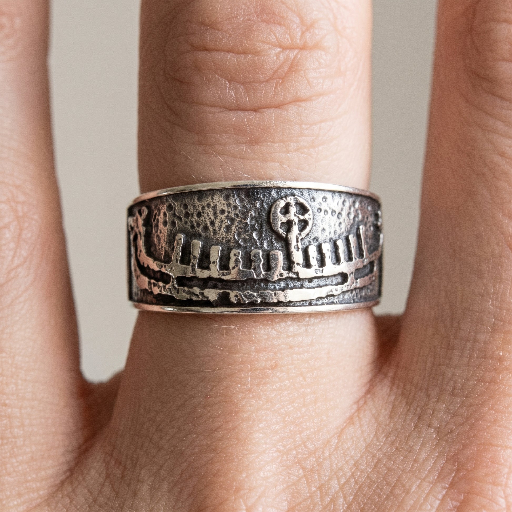 Silver Viking wedding ring with a drakkar longship worn on a finger