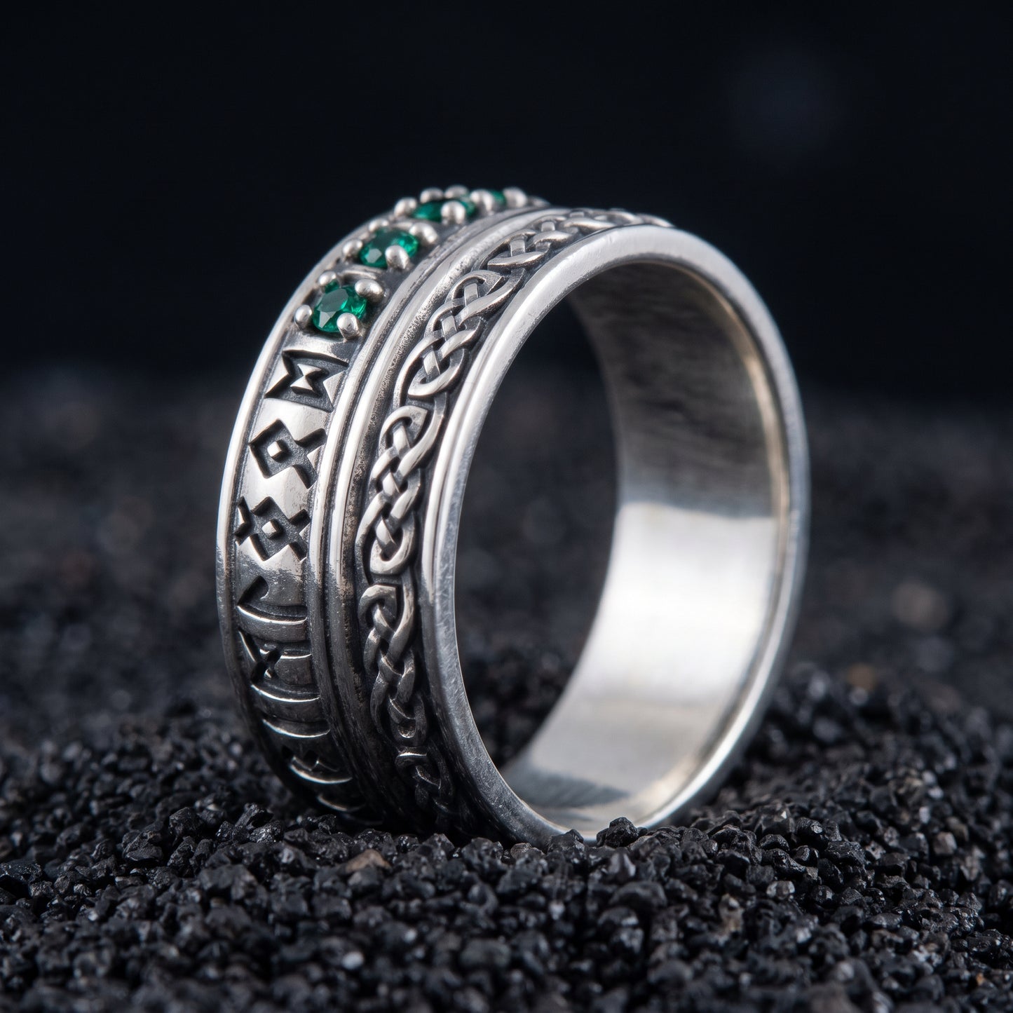 Sterling silver Viking wedding ring with Elder Futhark runes and green cubic zirconia on black volcanic sand
