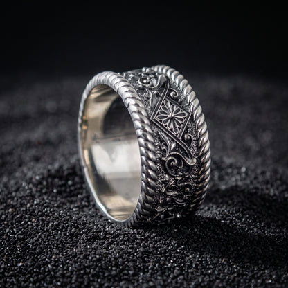 Viking wedding ring seen from the side, twisted rope rims and polished interior