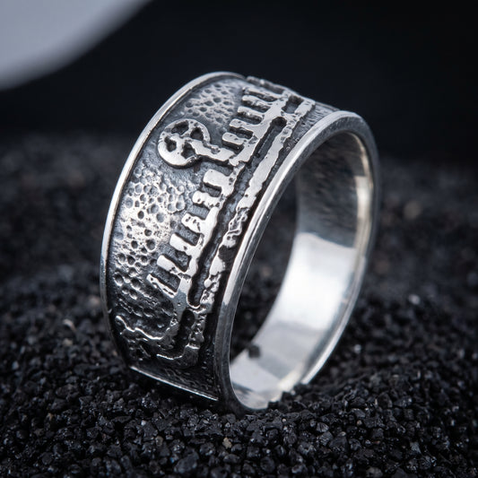 Sterling silver Viking wedding ring with a Norse drakkar longship in relief, on black volcanic sand